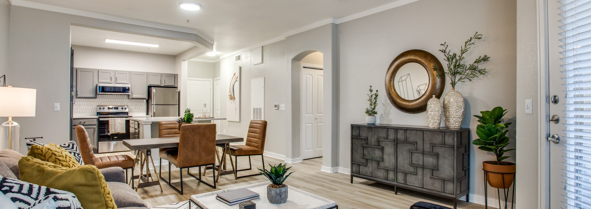a living room with a ceiling fan and a couch at The  Franklin at Samuels Ave