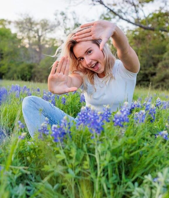 a woman in a field of bluebonnets at The  Franklin at Samuels Ave